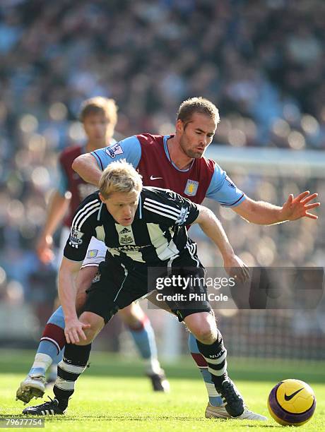 Olof Melberg of Aston Villa tackles Damien Duff of Newcastle United during the Barclays Premier League match between Aston Villa and Newcastle United...