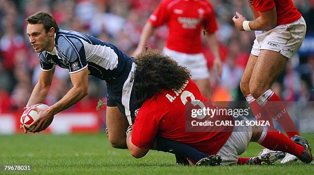 Wales' prop Adam Jones brings down Scotland's scrum half Mike Blair during their Six Nations Rugby Union match at the Millenium Stadium, in Cardiff,...