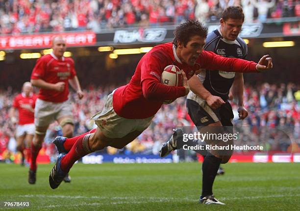 James Hook of Wales dives over to score his team's second try during the RBS 6 Nations match between Wales and Scotland at the Millennium Stadium on...
