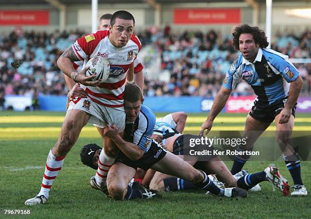 Harrison Hansen of Wigan Warriors holds off the challenge of Matt Gafa of Harlequins RL to score a try for his side during the engage Super League...