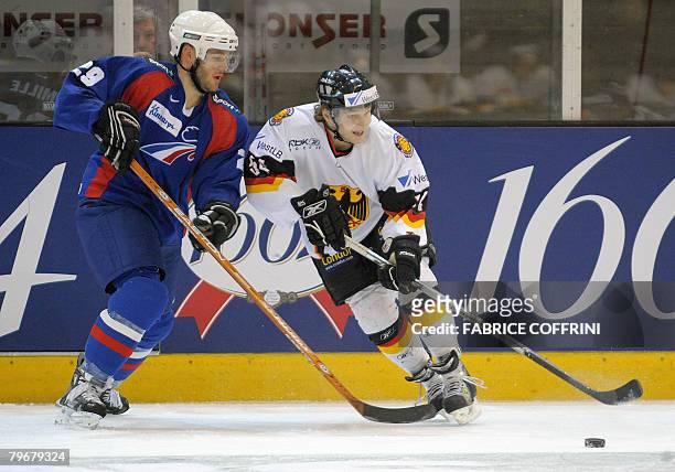 France's Mathieu Mille fights for the puck with Germany's Sebastian Furchner during their game at the international ice hockey Skoda Cup tournament...