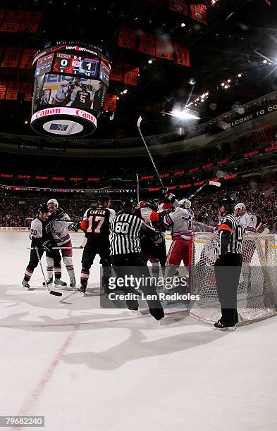Linesman Pat Dapuzzo separates a dispute between the Philadelphia Flyers and New York Rangers at the Wachovia Center February 9, 2008 in...