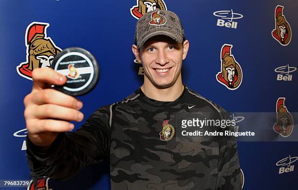 Jason Spezza of the Ottawa Senators poses with the puck he scored his first career hat trick with in a game against the Montreal Canadiens at...