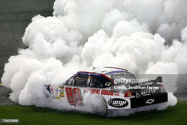 Dale Earnhardt Jr., driver of the Mountian Dew AMP/National Guard Chevrolet, burns out after winning the Budweiser Shootout at Daytona International...