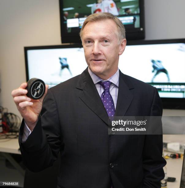 Head Coach Ron Wilson of the San Jose Sharks shows the puck from the game that gave him his 500th career win after an NHL game against the Nashville...
