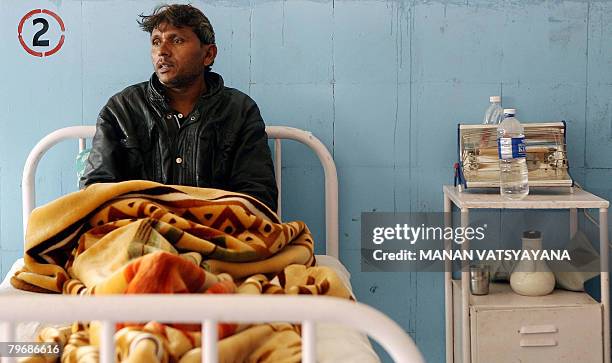 In this picture taken January 29 Indian labourer Mohammad Salim, rests on a hospital bed in Gurgaon some 30 kms south of New Delhi, after one of his...