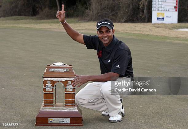 Chowrasia of India celebrates with the trophy after winning the final round of the Emaar-MGF Indian Masters at the Delhi Golf Club, on February 10,...