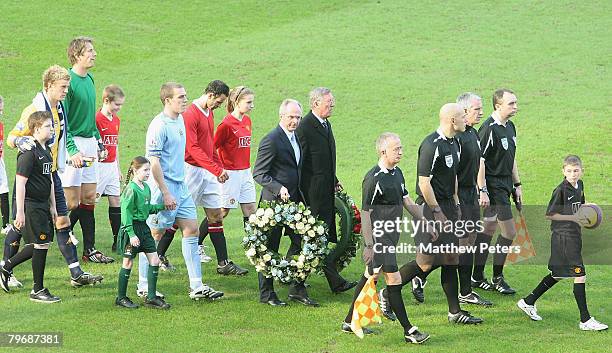 The two teams are led out by a lone piper in memory of the 23 victims of the Munich Air Disaster ahead of the Barclays FA Premier League match...