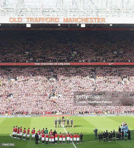 The two teams observe a minutes silence in memory of the 23 victims of the Munich Air Disaster ahead of the Barclays FA Premier League match between...