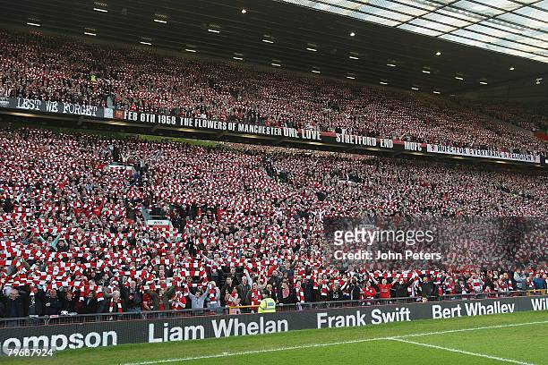 Manchester United fans hold up scarves in memory of the 23 victims of the Munich Air Disaster ahead of the Barclays FA Premier League match between...