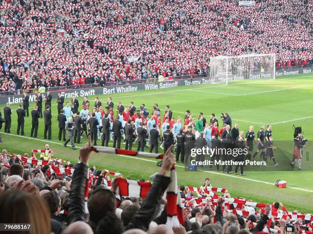 The two teams are led out by a lone piper in memory of the 23 victims of the Munich Air Disaster ahead of the Barclays FA Premier League match...
