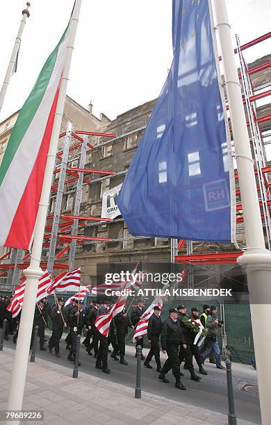 Framed by the EU and tricolor national flags, clad in black uniforms of Hungary's Nazi-aligned Arrow Cross party in WWII , local members of the...