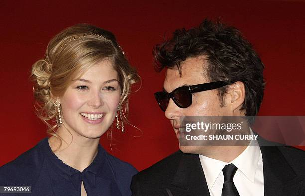 British actress Rosamund Pike and British film director Joe Wright arrive for the British Academy of Film and Television Awards in central London, on...