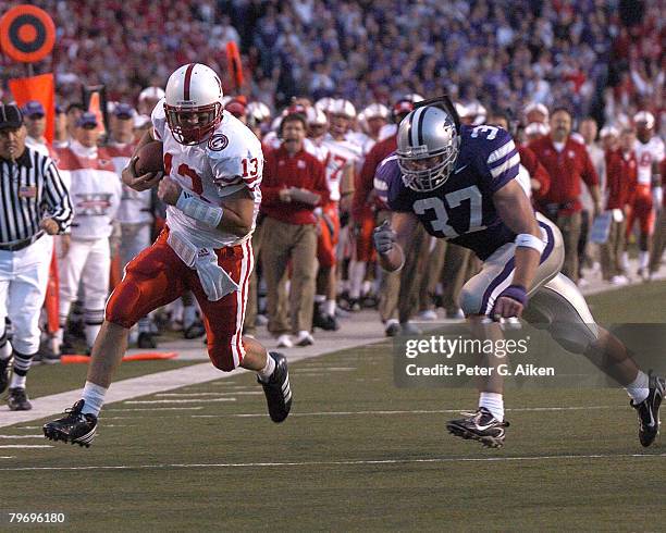 Nebraska quarterback Zac Taylor scrambles past Kansas State linebacker Marcus Perry for a first down in the first half at Bill Snyder Family Stadium...