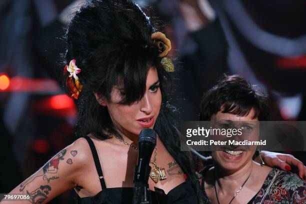 British singer Amy Winehouse hugs her mother Janis Winehouse after accepting a Grammy Award at the Riverside Studios for the 50th Grammy Awards...