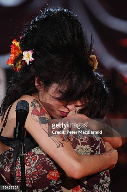 British singer Amy Winehouse hugs her mother Janis Winehouse after accepting a Grammy Award at the Riverside Studios for the 50th Grammy Awards...