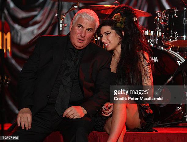 British singer Amy Winehouse sits with her father Mitch as they await news of her Grammy Award at The Riverside Studios for the 50th Grammy Awards...
