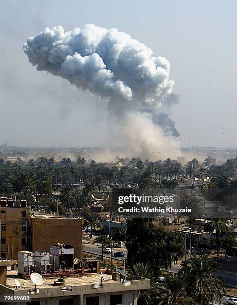 Huge plume of smoke rises from powerful explosions near the offices of the head of the Islamic Supreme Council of Iraq, Shiite cleric Abdul Aziz...