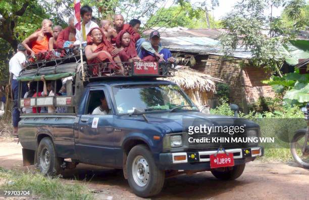 Buddhist monks ride atop a local taxi during their pilgrimage in Bago, some 90 km north-east of Yangon 28 October 2007. Life has almost return to...
