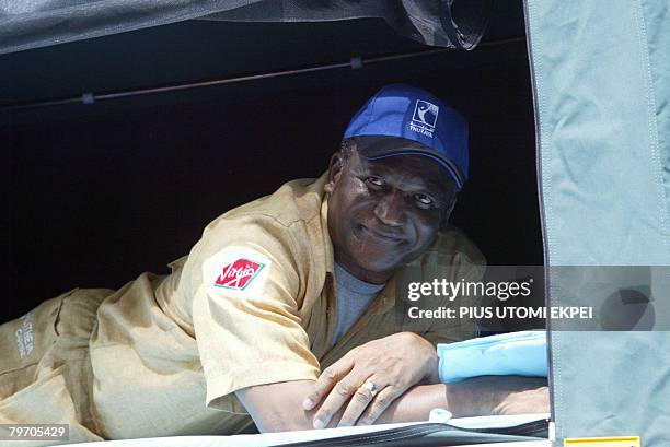 Leader of a six-man team on expedition to Sahara Desert, 70-year-old Newton Jibunoh lies on hanger for relaxation fitted on car being used for the...