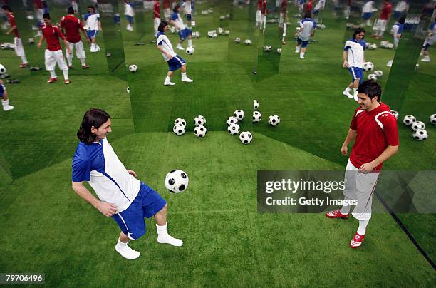 Barcelona player Lionel Messi juggles the ball with Valencia player David Villa during the adidas F50 TUNiT football boot launch on February 11, 2008...