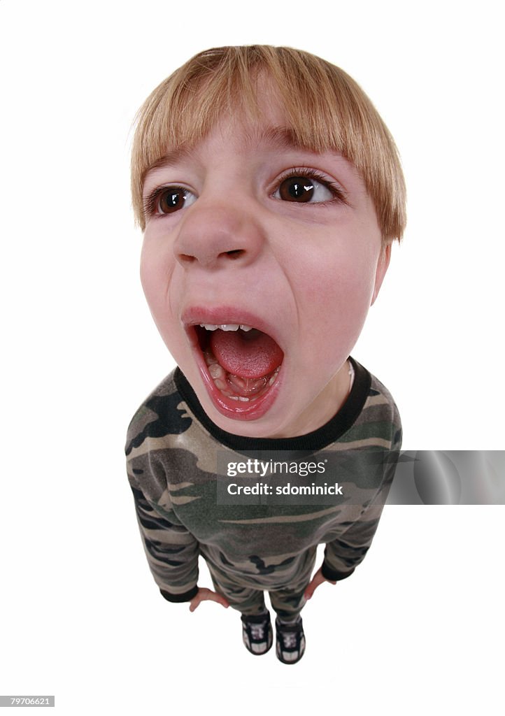 A humorous image of a screaming young boy. A fisheye lens was used.