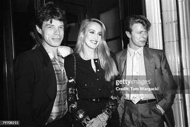 Mick Jagger, Jerry Hall and David Bowie at Langan's Brasserie on July 2, 1984 in London, England.