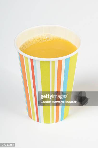 orange juice in paper cup, close up - o j howard stock pictures, royalty-free photos & images