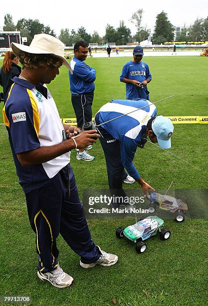 Lasith Malinga of Sri Lanka and MS Dhoni of India play with a remote control car as rain delays play before the Commonealth Bank Series One Day...
