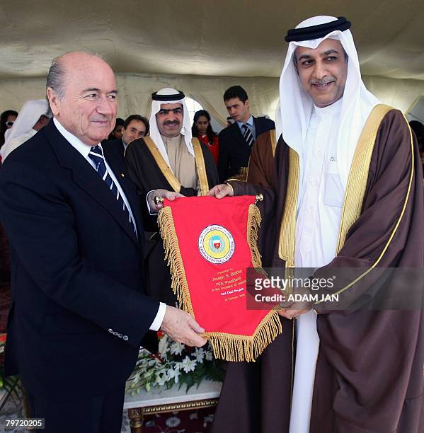 President Joseph Blatter receives a pennant from the President of the Bahraini Football Association, Sheikh Salman bin Ibrahim al-Khalifa in Manama...