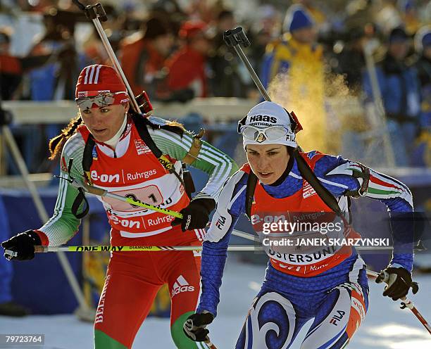 Ludmila Kalinchik of Bielarus competes next to Italian Michaela Ponza during the mix relay competition of the 2008 Biathlon Word Championships in...