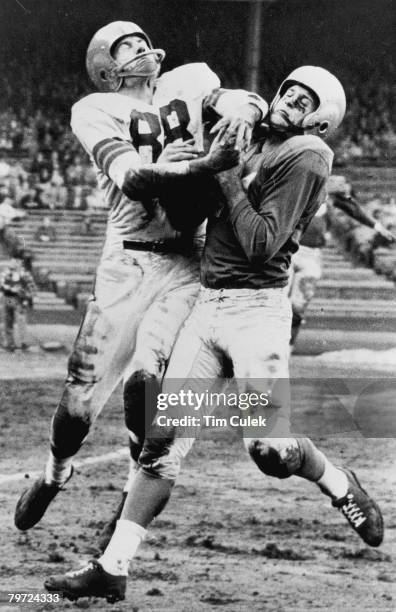 Detroit Lions Hall of Fame safety Jack Christiansen intercepts Cleveland Browns Hall of Fame quarterback Otto Graham's pass to Hall of Fame wide...