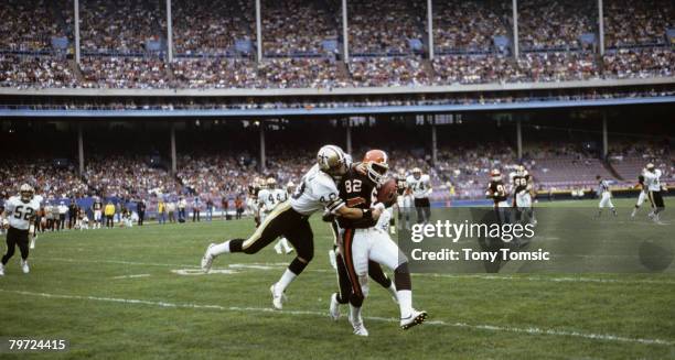 Cleveland Browns Hall of Fame tight end Ozzie Newsome makes a catch with the defender draped all over him during a 16-14 loss to the New Orleans...