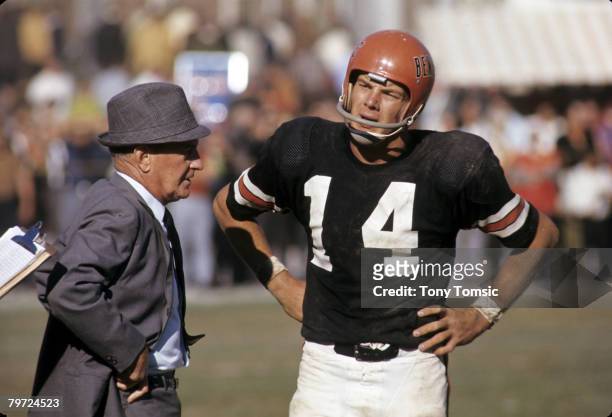 Cincinnati Bengals Hall of Fame head coach Paul Brown talks with quarterback Sam Wyche during a game in 1969.