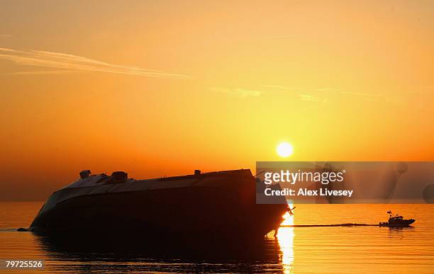 The sun sun sets over the stricken ferry 'Riverdance' as it sits on a sandbank off Blackpool's North Shore at Cleveleys on February 12, 2008 in...