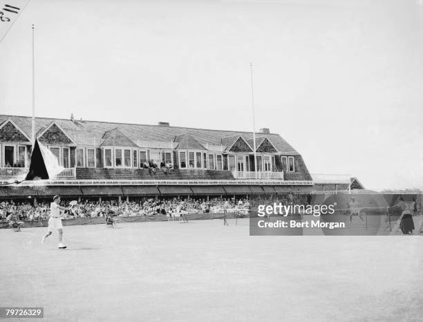 Two unidentified tennis players compete in a match, watched by an audience at the Meadow Club, Southampton, New York, September 17, 1945.