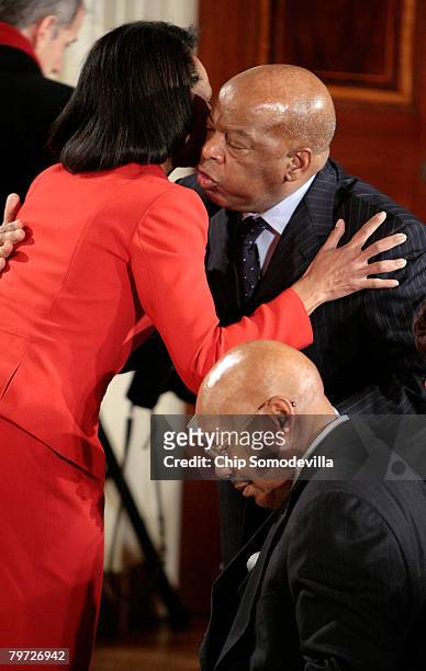 Secretary of State Condoleeza Rice embraces Rep. John Lewis as Housing and Urban Development Secretary Alphonso Jackson sits by during an African...