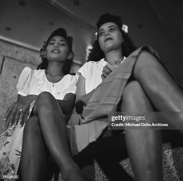 Two girls watch the action at a nightclub in 1946 in Kingston, Jamaica.