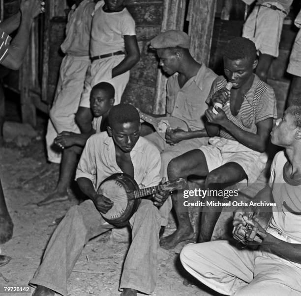 Group of Maroon musicians play on the steps of a general store in the mountain region known as Cockpit Country in 1946 in Accompong, Jamaica.