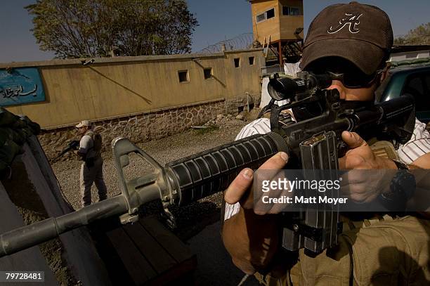 Private security contractor, Neil Gary , a former US Marine, takes a defensive position rides while providing security for a convoy November 1, 2005...