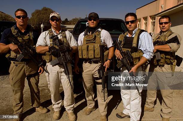Private security contractors Pat Scott, Mike Stocksett Neil Gary Matt Goss and Kyle Kaszynski pose for a photograph while on a break from providing...