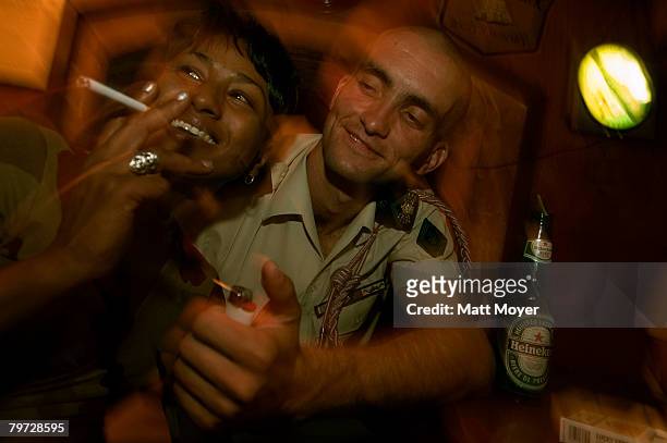 Rotaru Florin, a member of the French Foreign Legion, picks up a woman at a bar September 23, 2005 in Nimes, France. The French Foreign Legion is...