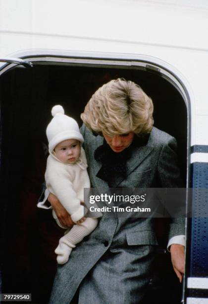 Diana, Princess of Wales carries her son, Prince Harry, off a flight at Aberdeen Airport en route to Balmoral, Scotland, 22nd March 1985.