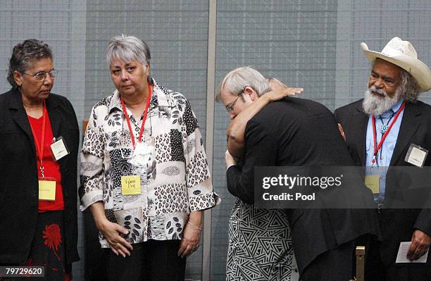 Australian Prime Minister Kevin Rudd embraces a member of Australia's Stolen Generation after delivering a speech in which he apologized to its...