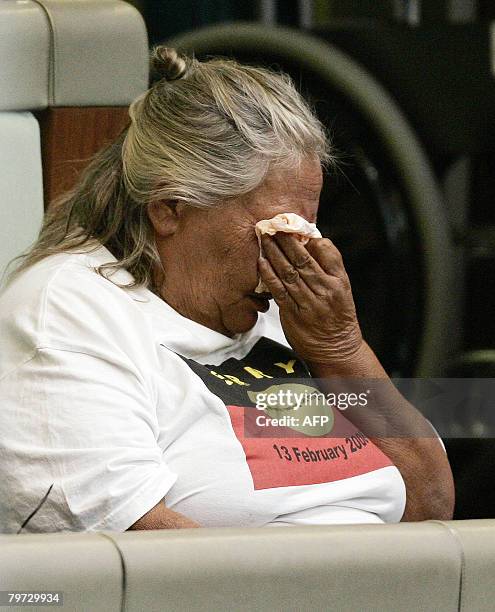 An Indigenous Australian wipes her eyes as Australian Prime Minister Kevin Rudd delivers an apology to the Aboriginal people for injustices committed...