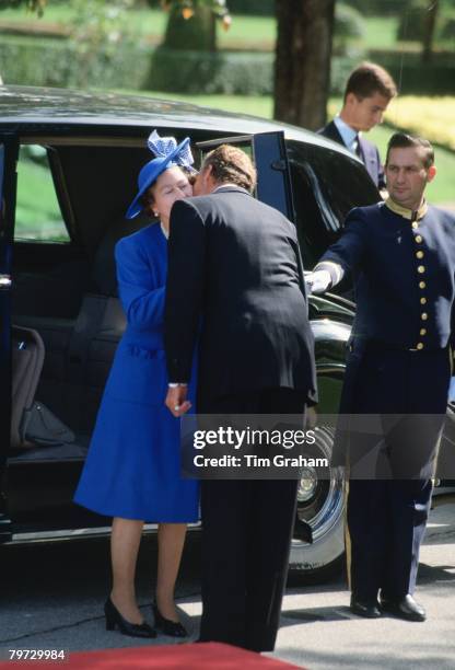 Queen Elizabeth II is greeted by King Juan Carlos of Spain during a visit to Madrid