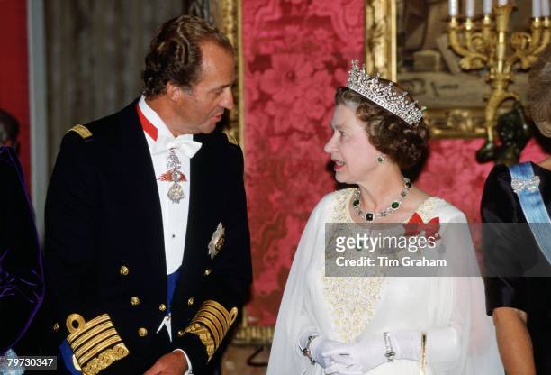 On the first night of her official tour of Spain, Queen Elizabeth II is invited to a state banquet at the Oriente Palace and meets King Juan Carlos
