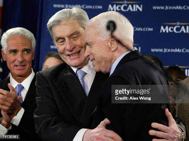 Presidential hopeful Sen. John McCain is hugged by U.S. Sen. John Warner as Florida Gov. Charlie Crist looks on during a primary night party February...