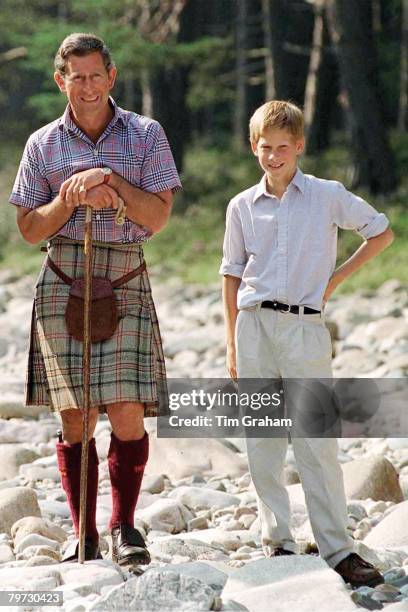 UNITED KINGDOM PRINCE CHARLES WITH PRINCE HARRY AT POLVIER, BY THE RIVER DEE, BALMORAL CASTLE ESTATE