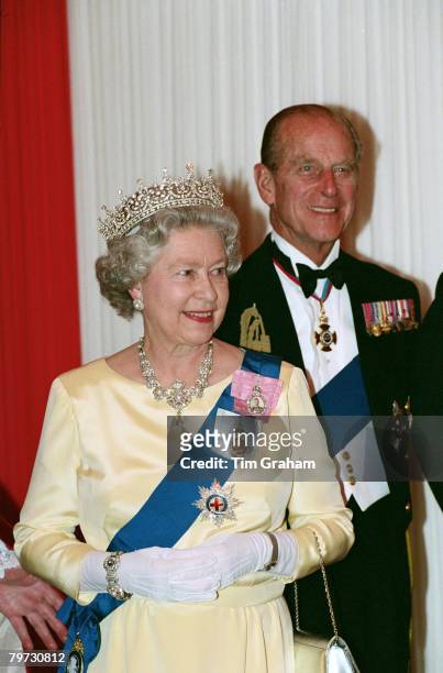 Queen Elizabeth II and Prince Philip, Duke of Edinburgh attend a Heads of State Banquet at the Guildhall to commemorate the 50th anniversary of the...